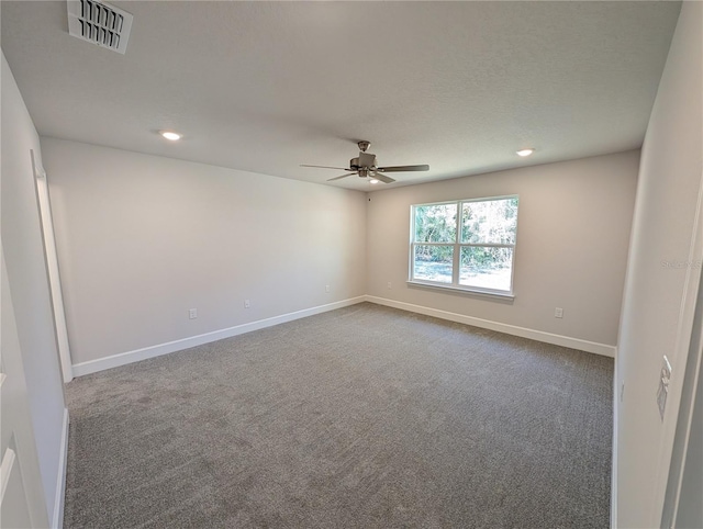 spare room with ceiling fan, carpet, and a textured ceiling