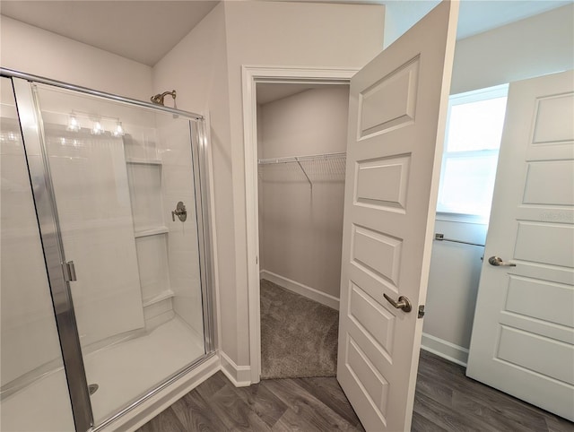 bathroom with an enclosed shower and hardwood / wood-style floors