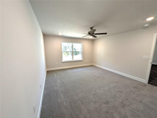 carpeted empty room with ceiling fan and a textured ceiling