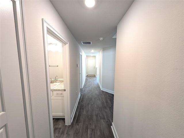 hall with dark hardwood / wood-style floors and sink