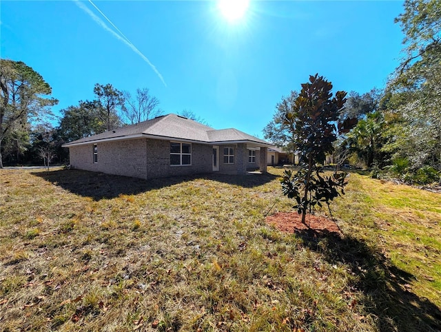 rear view of property with a yard