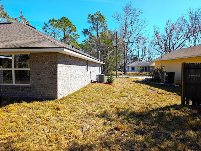 view of yard featuring central air condition unit