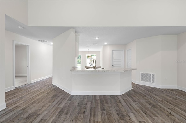 15 Serene Pl, Palm Coast, FL 32164 - unfurnished living room featuring dark wood-style floors, a sink, baseboards, and recessed lighting