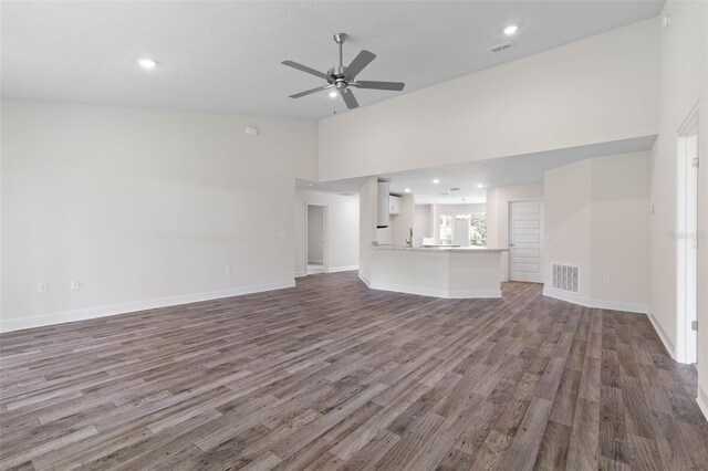 15 Serene Pl, Palm Coast, FL 32164 - unfurnished living room featuring wood finished floors, a ceiling fan, recessed lighting, baseboards, and high vaulted ceiling