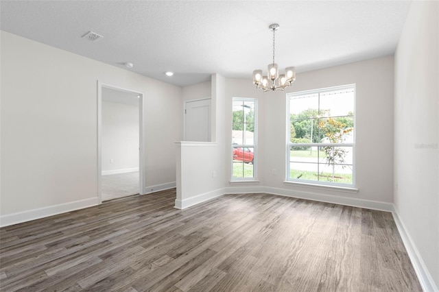 15 Serene Pl, Palm Coast, FL 32164 - unfurnished room with a chandelier, wood finished floors, and baseboards
