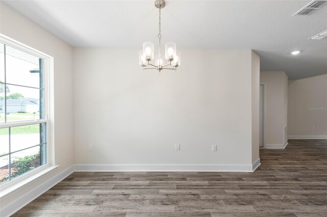 15 Serene Pl, Palm Coast, FL 32164 - spare room featuring wood finished floors, a chandelier, baseboards, and recessed lighting