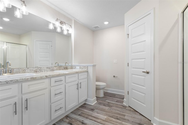 15 Serene Pl, Palm Coast, FL 32164 - bathroom featuring a stall shower, wood finished floors, toilet, baseboards, and double vanity