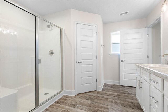 15 Serene Pl, Palm Coast, FL 32164 - bathroom with a shower stall, wood finished floors, baseboards, and vanity