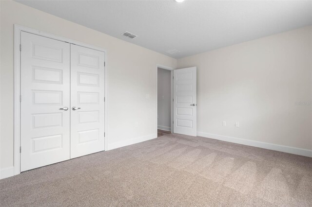 15 Serene Pl, Palm Coast, FL 32164 - unfurnished bedroom with carpet flooring, baseboards, and a closet