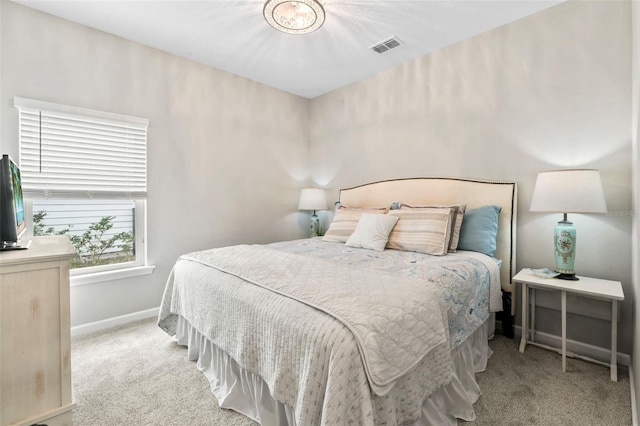 carpeted bedroom featuring visible vents and baseboards