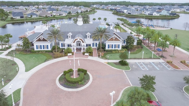 drone / aerial view with a residential view and a water view