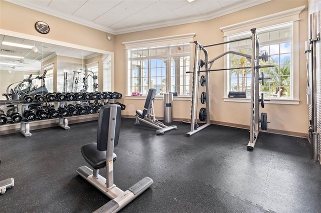 gym with a wealth of natural light, baseboards, and crown molding