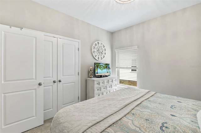 bedroom featuring a closet and light carpet