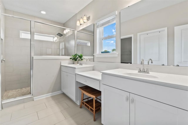 bathroom with double vanity, tile patterned flooring, a shower stall, and a sink