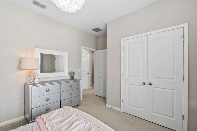 bedroom with light colored carpet, visible vents, and baseboards