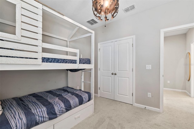 carpeted bedroom with baseboards, visible vents, and a closet