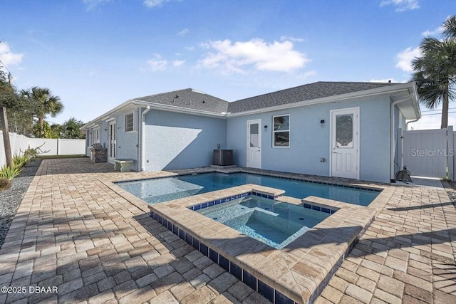 view of pool with an in ground hot tub, a patio area, and central air condition unit