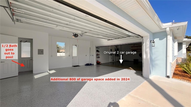 garage with electric panel and a garage door opener