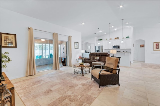 living room featuring high vaulted ceiling and light tile patterned floors