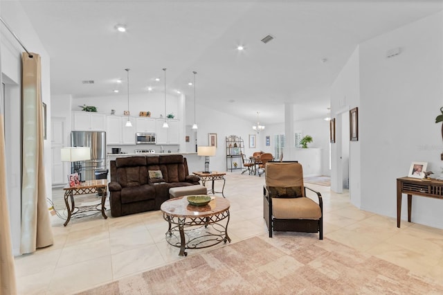 tiled living room with lofted ceiling and an inviting chandelier