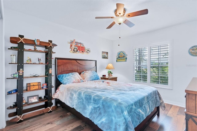 bedroom featuring dark hardwood / wood-style flooring and ceiling fan