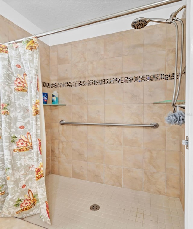 bathroom featuring a textured ceiling and walk in shower