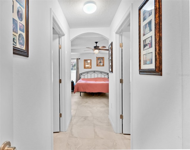 corridor with a textured ceiling