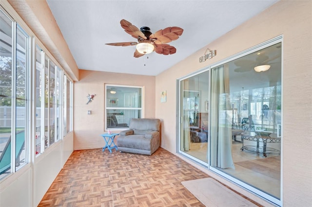 sunroom featuring ceiling fan