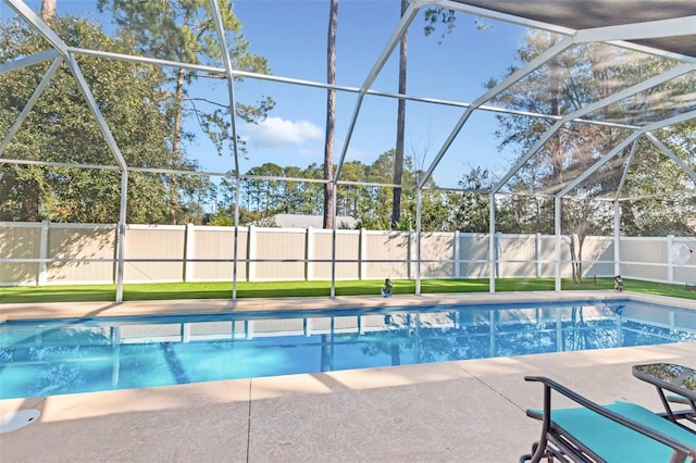 view of swimming pool with a lanai and a patio area