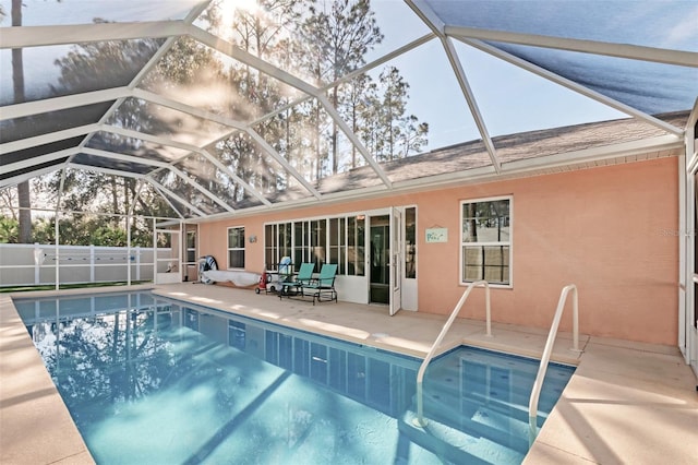 view of pool featuring a patio and glass enclosure