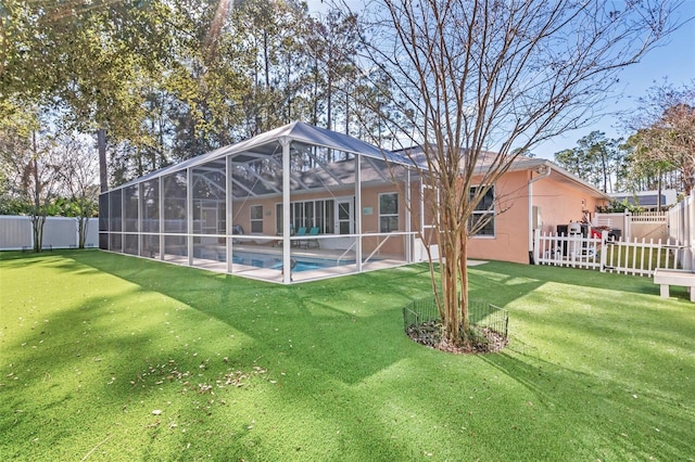 rear view of property featuring a fenced in pool, glass enclosure, and a lawn