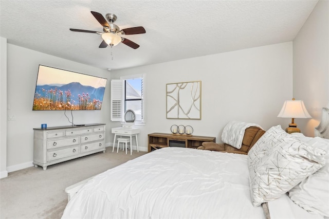 bedroom featuring carpet flooring, ceiling fan, a textured ceiling, and baseboards