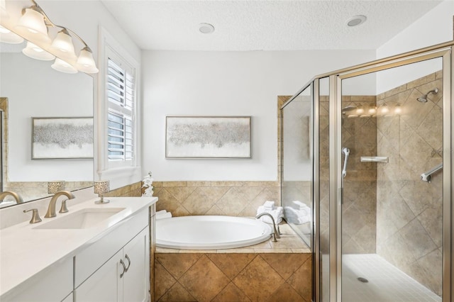 bathroom with vanity, plus walk in shower, and a textured ceiling