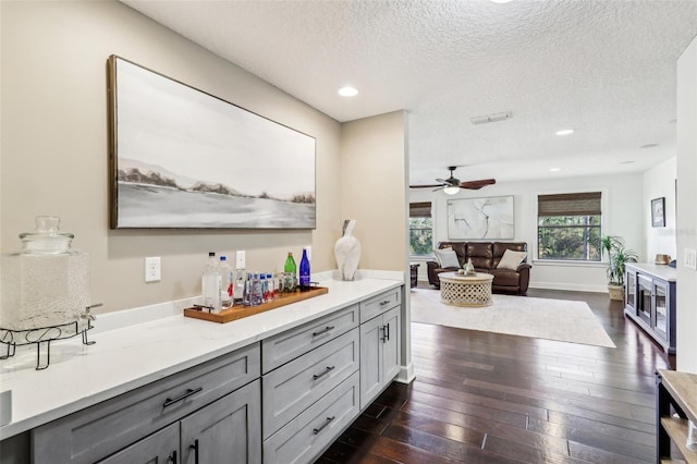 bathroom featuring visible vents, a ceiling fan, hardwood / wood-style flooring, a textured ceiling, and recessed lighting