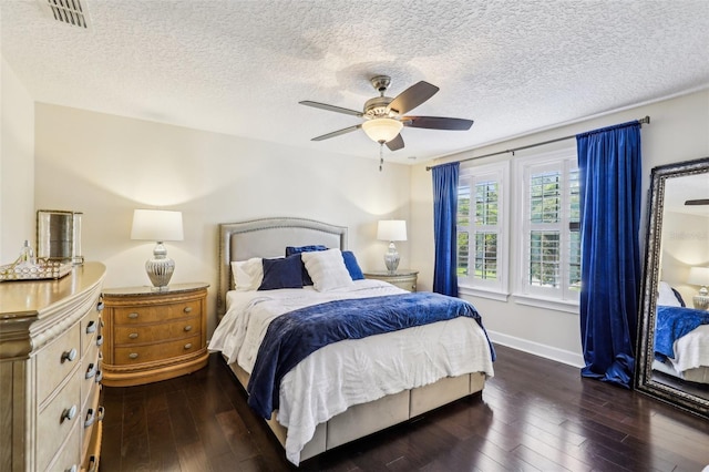 bedroom featuring ceiling fan, a textured ceiling, and dark hardwood / wood-style flooring