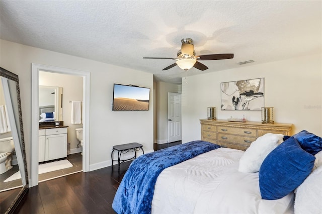 bedroom featuring ceiling fan, dark hardwood / wood-style floors, and a textured ceiling