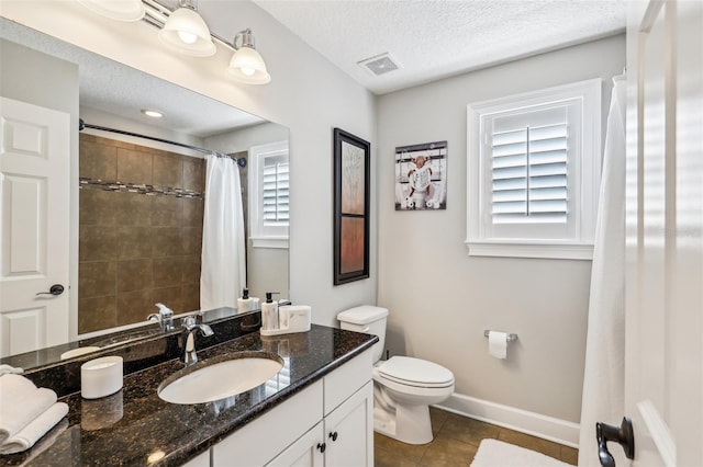 bathroom with tile patterned flooring, a shower with shower curtain, vanity, a textured ceiling, and toilet