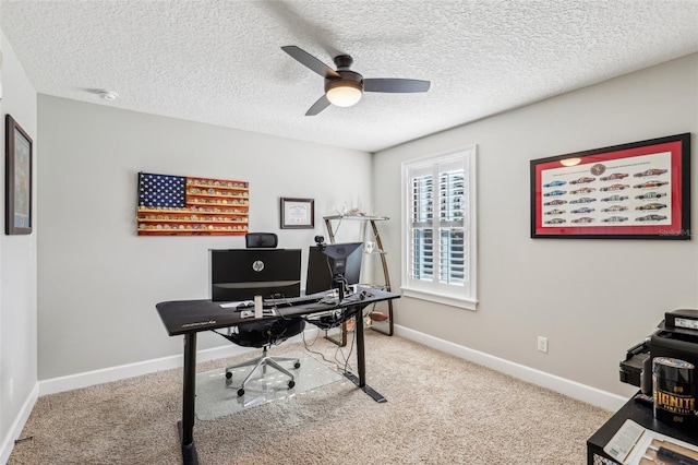 carpeted office featuring ceiling fan and a textured ceiling