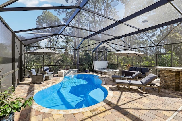 outdoor pool featuring glass enclosure, a patio area, and an outdoor hangout area