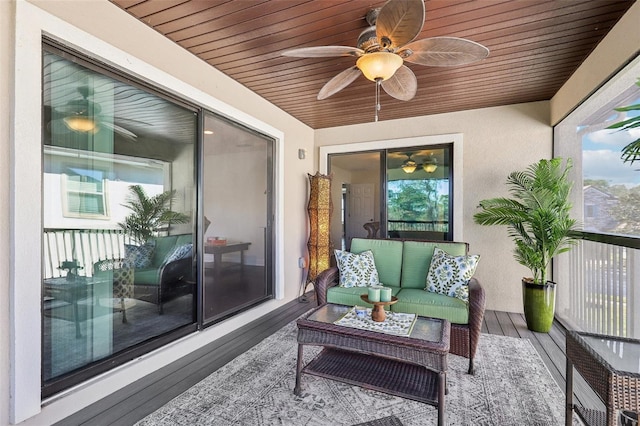 sunroom with ceiling fan and wooden ceiling