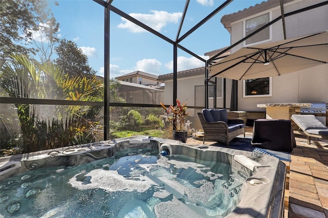 view of patio / terrace featuring a hot tub and glass enclosure