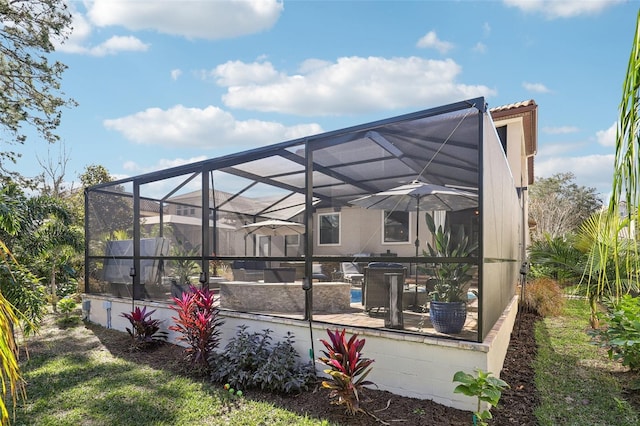 rear view of house with a swimming pool, a patio, and a lanai