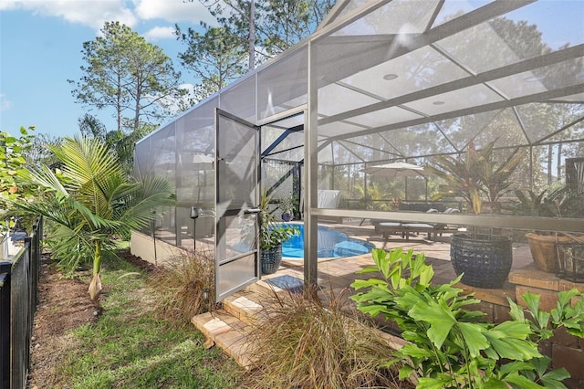 outdoor pool with glass enclosure and a patio