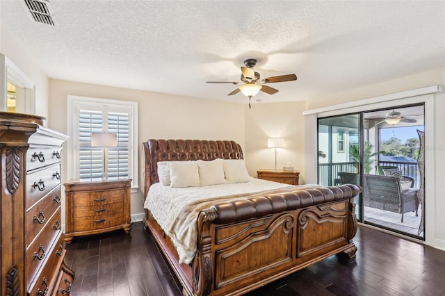 bedroom featuring visible vents, ceiling fan, dark wood finished floors, a textured ceiling, and access to outside