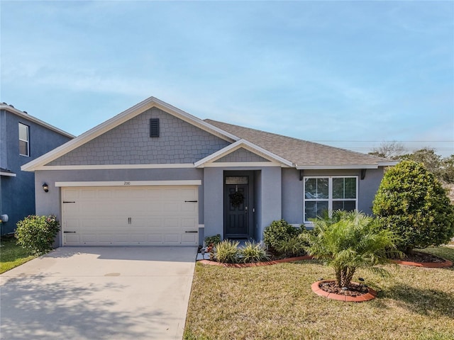 view of front of home featuring a garage and a front lawn