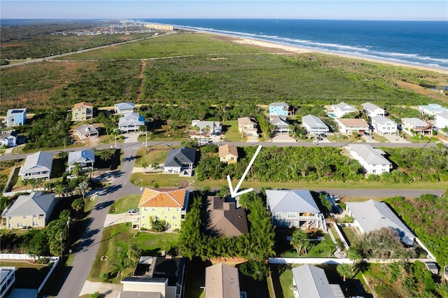 birds eye view of property featuring a view of the beach and a water view