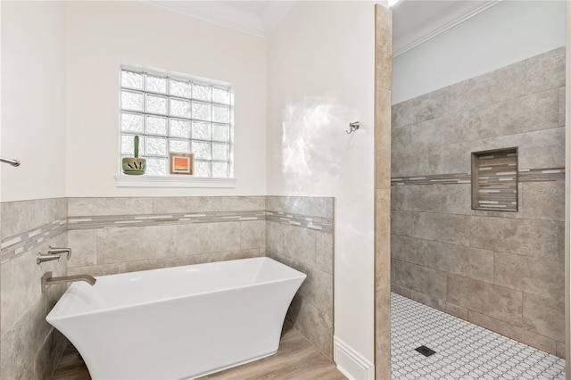 bathroom with crown molding, shower with separate bathtub, and tile walls