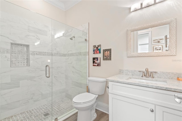 bathroom with walk in shower, toilet, crown molding, wood-type flooring, and vanity