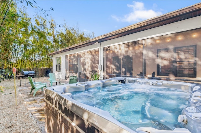 view of patio / terrace with a hot tub