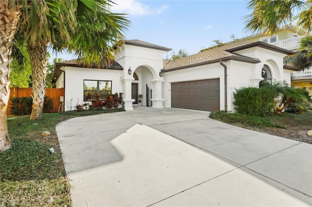 mediterranean / spanish-style home with a garage